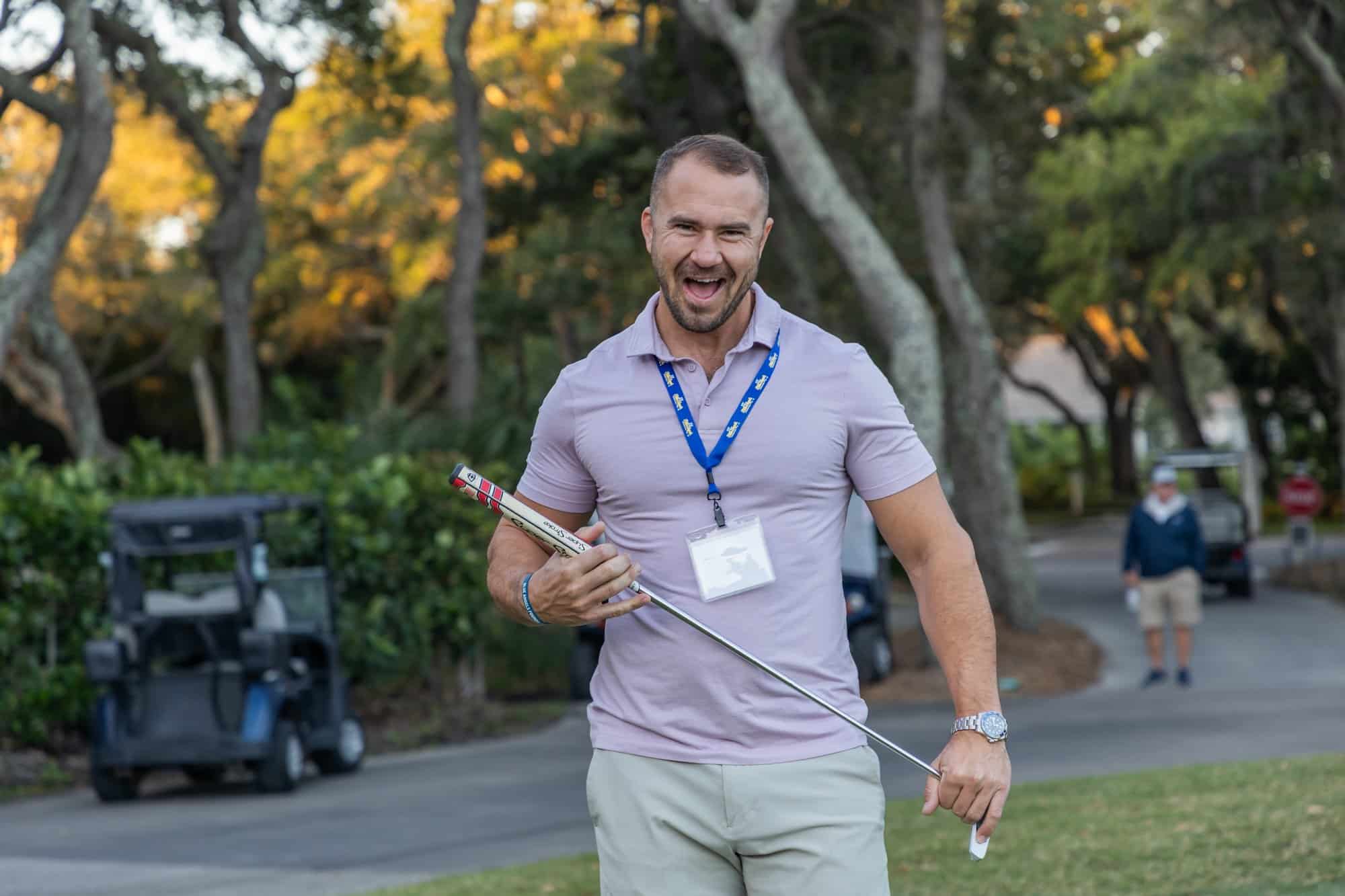 Young military man saluting with the American flag in the background